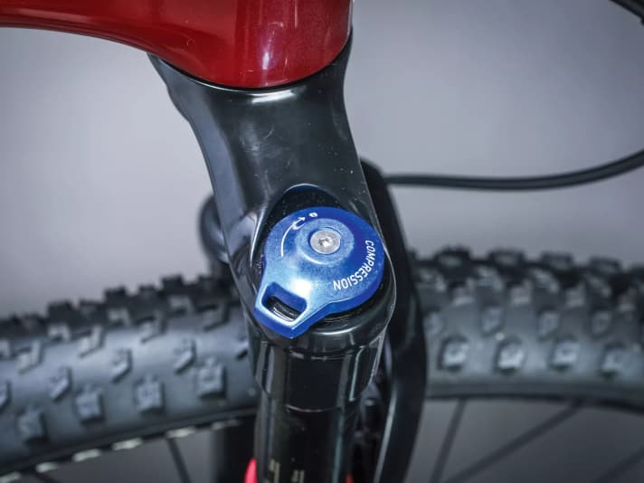 The compression stage usually has a blue adjustment knob.