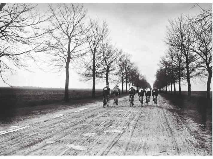 historical photo of cyclists on a lonely road