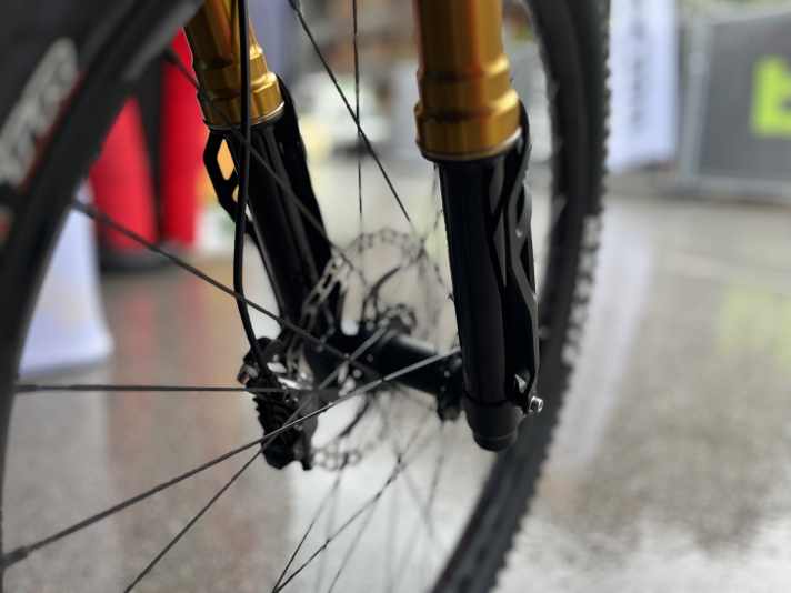 Upside down. With upside-down forks, the thicker stanchions are at the top and the thinner down tubes at the bottom.