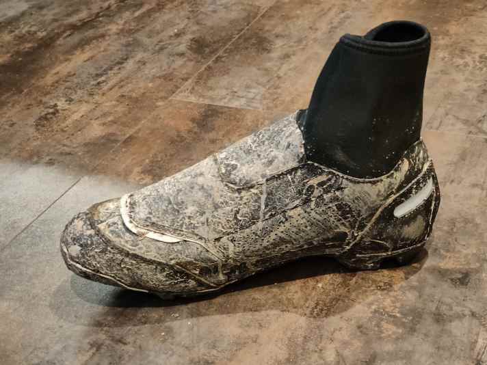 If it gets damp in the shoe, it is due to condensation that forms in the neoprene cuff.