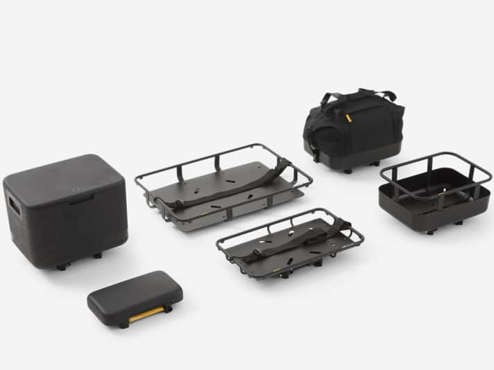 Das B’Clip-System umfasst sechs Module: ein Sitzpolster für Mitfahrende, eine Transportbox, einen vorne und hinten montierbaren Korb, eine Transporttasche sowie zwei Plattformen in den Größen M und XL mit Spanngurten.
