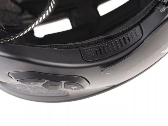 The speakers are recessed into the side of the helmet shell.