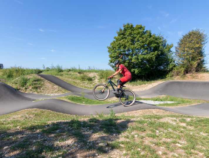 Here Steffi Marth surfs over waves on the pump track on her dirt bike.