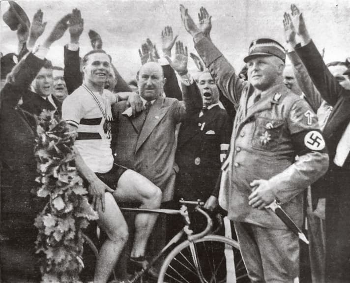 Without a salute: Albert Richter wins the 1934 German Championships in Hanover. Claquemen and Nazi henchmen raise their arms to salute Hitler, Richter refuses. He died under mysterious circumstances in a Gestapo prison in 1940.