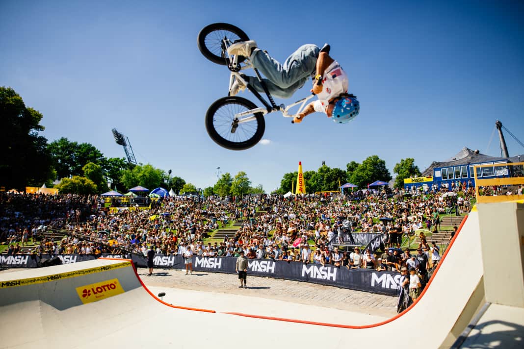 The BMXers flair up the halfpipe.
