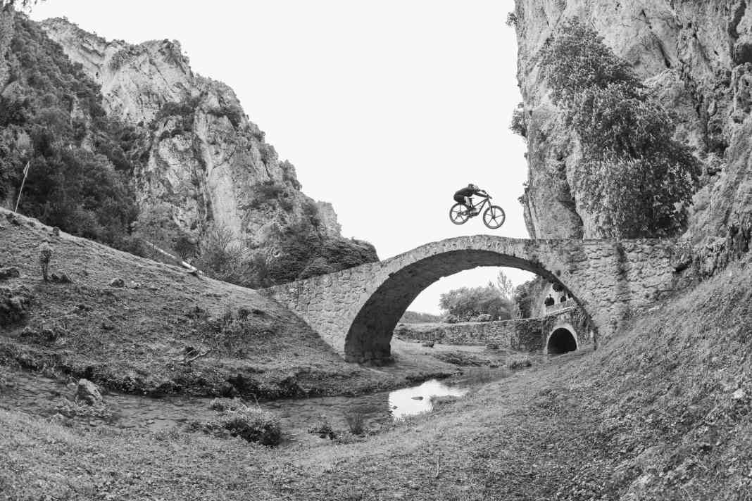 David Cachon jumps over the stone bridge in the smallest village in the world: Illán de Vacas. Only three people still live here.