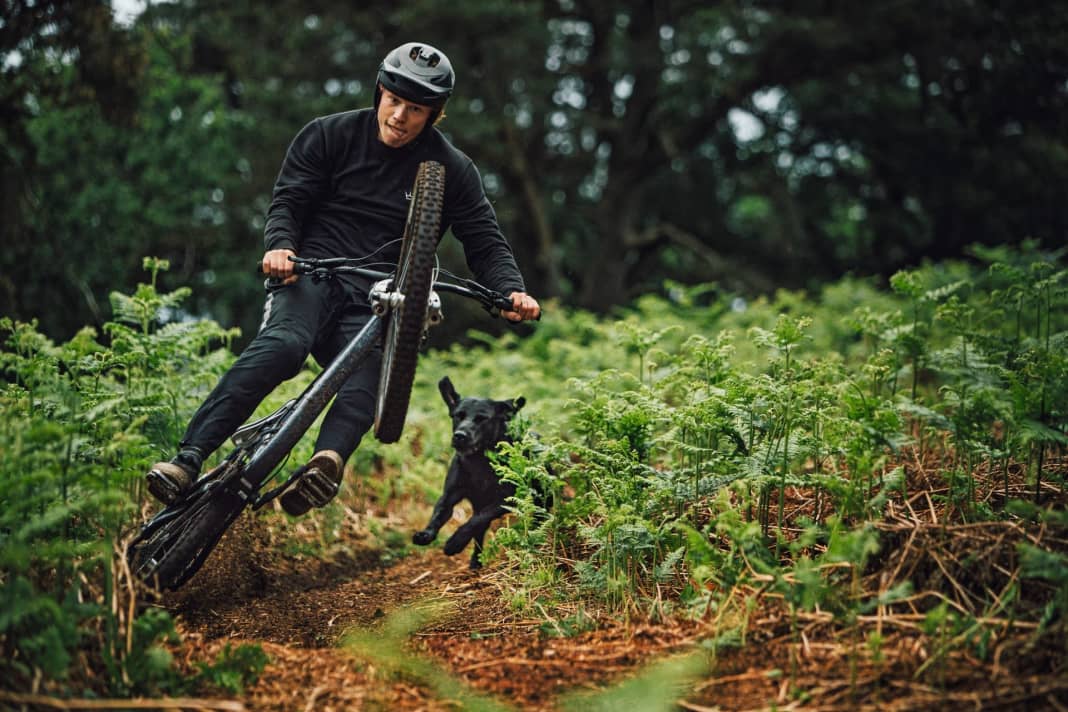 Braaap! 50to01 shredder Sam Hockenhull mills through his home trail, his dog follows. Legal trails near the city are seen as a solution to conflicts in the forest.