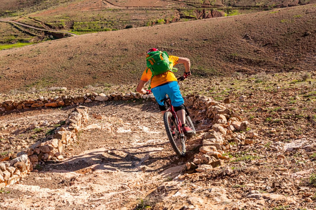 Außen: Die Ideallinie zählt! Fahre außen an und passe Deine Geschwindigkeit bereits jetzt an – im Idealfall bremst Du später nicht mehr. Strecke Deinen kurveninneren Arm. Folge: Dein Bike legt sich in die Kurve. Der Blick richtet sich bereits zum Kurvenausgang. Damit gibst Du die Fahrtrichtung vor.