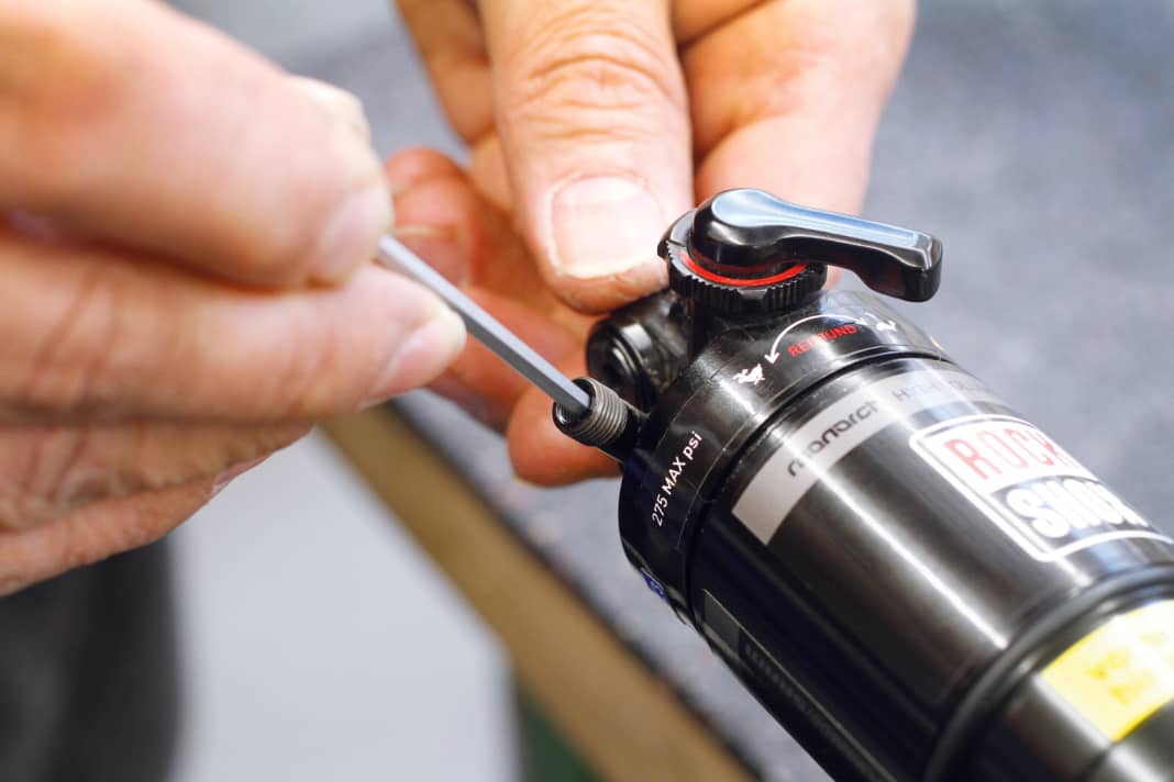 1. Luft ablassen Um später wieder leichter das richtige Setup zu finden, ermitteln Sie zunächst den Luftdruck im Dämpfer mit einer Dämpferpumpe. Anschließend die komplette Luft ablassen. Um das Dämpfergehäuse abziehen zu können, müssen Sie breite Buchsen aus dem Dämpferauge auf der Kolbenseite herausziehen.