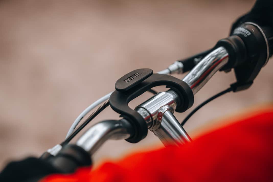 The adapter is slid over the handlebars.