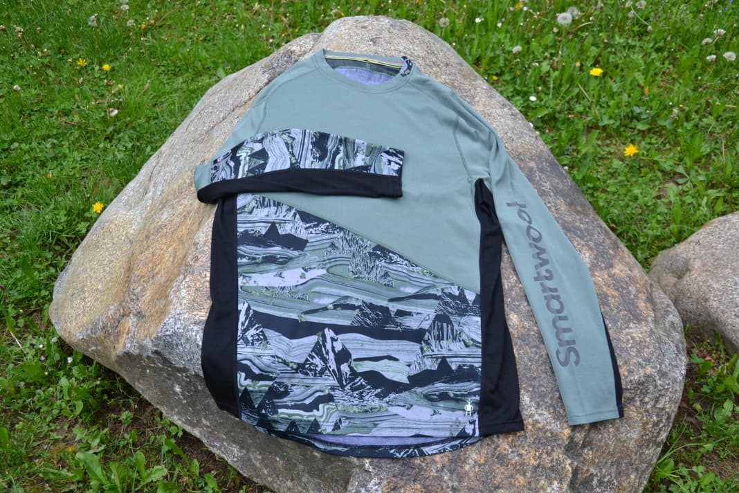 The Smartwool MTB long-sleeved shirt lies on a cool stone and relaxes.