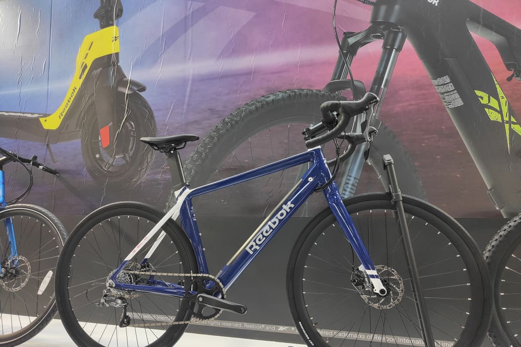 Etwas unscheinbar stellt der ehemalige Sport-Riese Reebok seine ersten E-Bikes auf der ISPO vor. Ja, Reebok hat jetzt eine Auswahl von E-MTBs, E-Gravelbikes, E-Commuter...