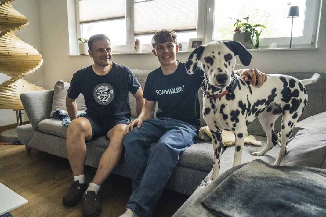 The Klausmanns on the sofa at home with the family dog.