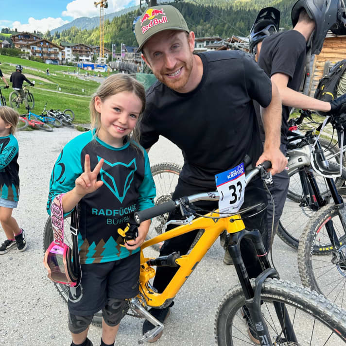 Paula with YouTube star Danny MacAskill and her race bike at the Kids Cup at the BIKE Festival Leogang.