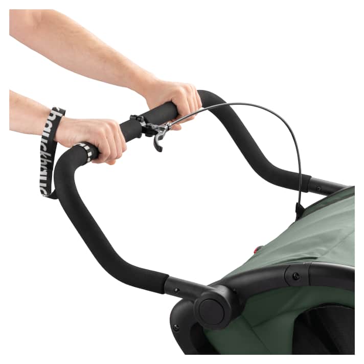 A hand strap secures the buggy to the parent's arm to prevent the child from suddenly rolling off-road