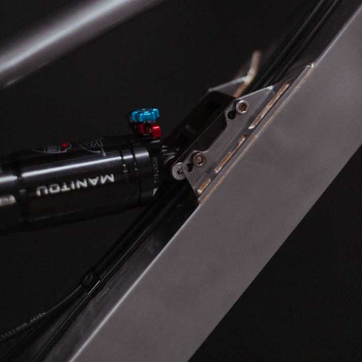 Apparently the damper is bolted to the frame with a separate slide.