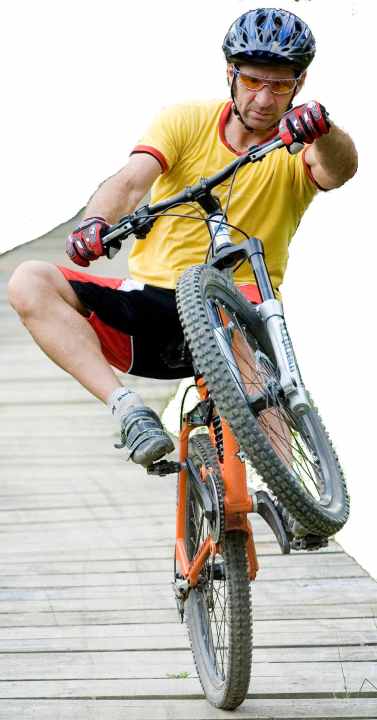   The arms are always stretched when doing a wheelie on a mountain bike.