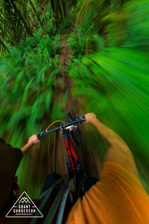   Professional biker KC Deane in a singletrack frenzy somewhere in British Columbia. Everyone will agree that it's an awesome feeling. But why does biking actually make us so happy?