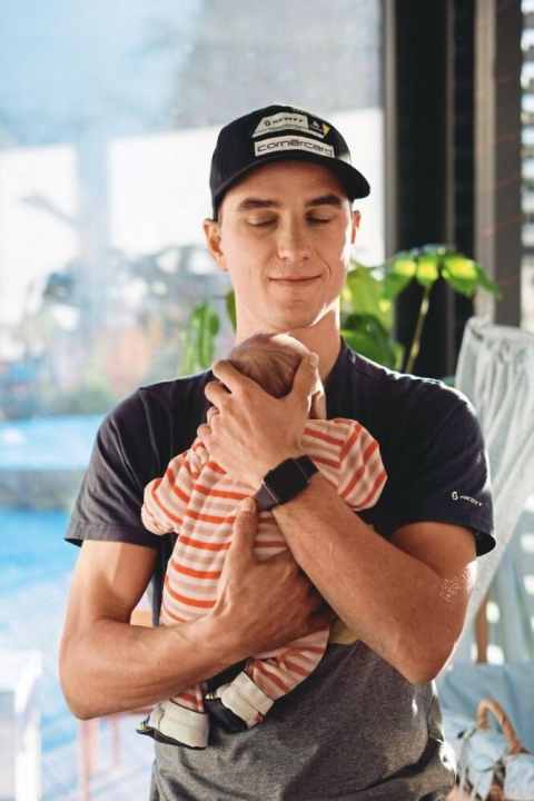   He describes the birth of his daughter Lisa-Sophia as the most emotional moment of his life. Note the rainbow stripes on the baby's shoes.