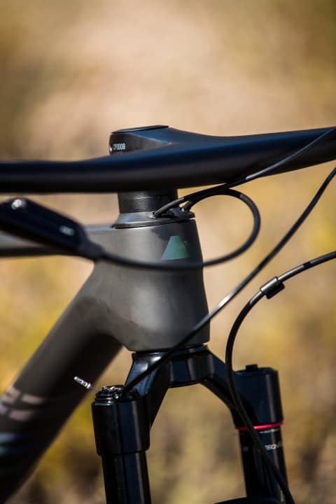   The cables disappear into the frame under the stem via the headset cap.