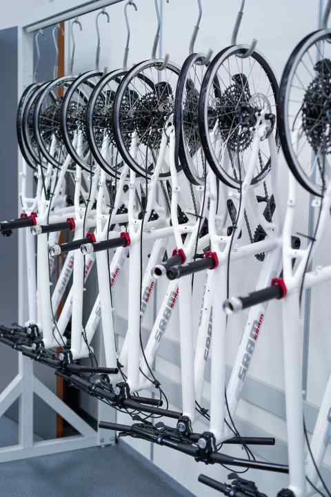   Just the bare essentials: The white MTB fragments are called "fake bikes" and are used purely for training purposes. They are normally used to teach dealers how to bleed brakes or adjust gears as part of workshops. The frames only contain the parts that are necessary for this.