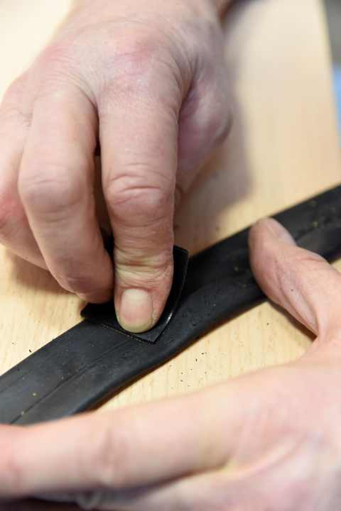 Roughen a patch-sized area with the sandpaper.