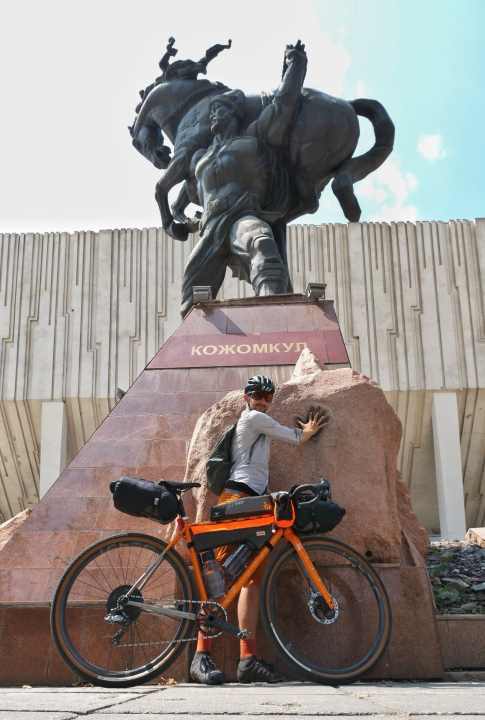   Kyrgyz national symbol. The Kyrgyz wrestler Kozhomkul carries his horse on his shoulders. The statue stands in front of the Sports Palace in the capital Bishkek. The real Kozhomkul lived from 1888 to 1955.
