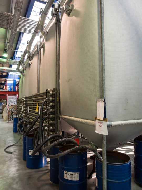   ...or large silos and is fed to the injection moulds via a pipe system.