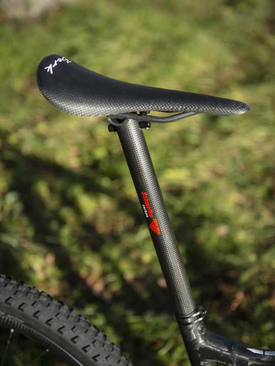   The carbon saddle from Berk Composites weighs 60.7 grams, the Schmolke TLO post 112.5 grams.