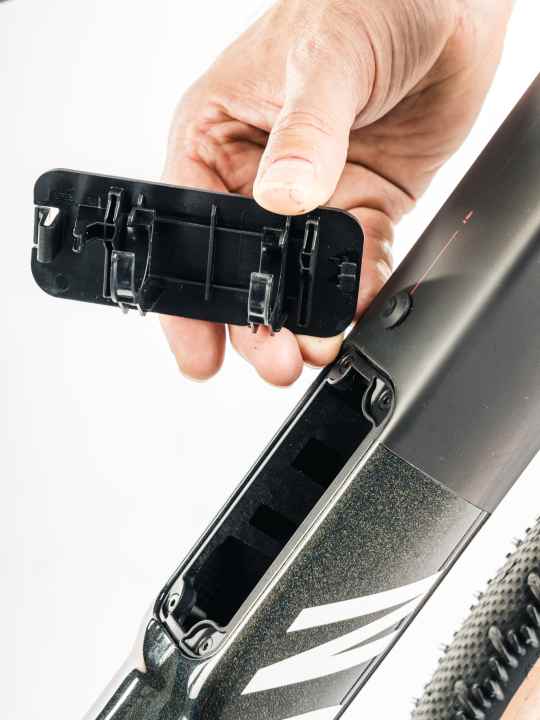 The storage compartment in the down tube offers plenty of space. There is plenty of room for a full puncture repair kit, and a multi-tool and mini pump can also be attached to the plastic lid.