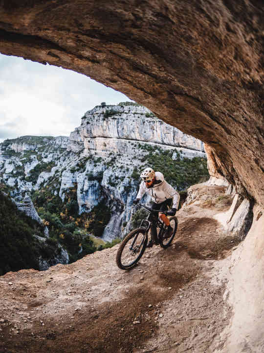 Dicht am Abgrund! Bike-Abenteurer David Cachon rollt durch die Felsgalerie des Chemin de la Mâture in den Pyrenäen.