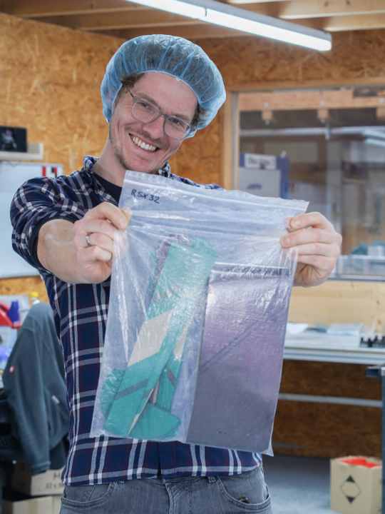 The high-end wheel is to be created from a bag of carbon scraps. Hairnets are compulsory in the laminating hall.