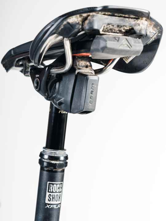 The Rockshox Vario seatpost can be lowered by pressing the shift buttons at the same time.
