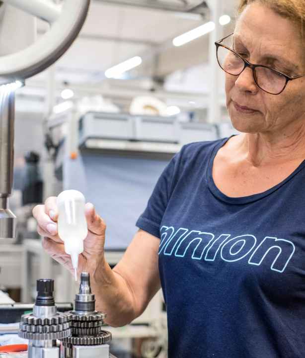 Lubricated: Before she closes the housing and fills it with gear oil, an employee lubricates the pawls.