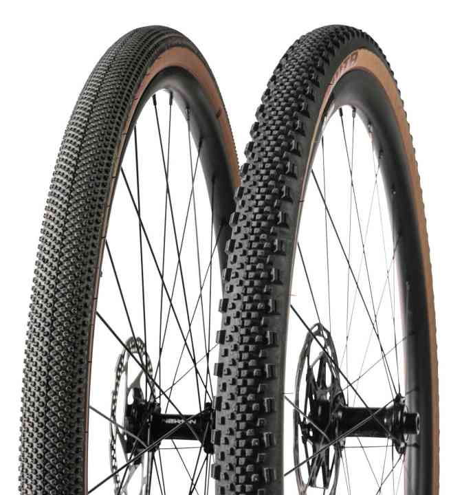 Gravel tyres are available from almost treadless to with thick studs.
