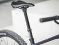 The dropper post gets the saddle out of the way on downhills, and the rider stands securely on the bike.