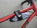 The Wolf Tooth roll bag can be attached to the frame either via a solid aluminium plate or directly using a Velcro strap