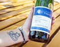 The profession gets under your skin: the winemaker and former wine princess proudly presents her award-winning wine and her tattoo with a traditional Bocksbeutel and Römer wine glass.