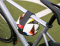 It enables the safe transport of footballs, basketballs or handballs on a bicycle.