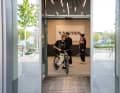As soon as the door opens... an MTB rides up.