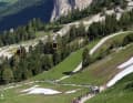 A colourful, seemingly endless worm made of Lycra winds its way up the serpentines on the Sella Ronda Hero.
