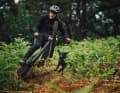 Braaap! 50to01 shredder Sam Hockenhull mills through his home trail, his dog follows. Legal trails near the city are seen as a solution to conflicts in the forest.