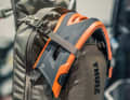 There is space for the full-face helmet on the upper straps. Or even just a part of it.