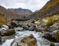 The wooden bridge over the Tasnan is rustic but beautiful. The more challenging part of the descent is just behind us here.