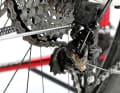3. you must now use the wrap screw to correctly adjust the distance between the rear derailleur and the sprockets. To do this, shift to the largest sprocket and turn the wrap screw in until the upper derailleur pulley is a few millimetres below the large sprocket. The derailleur pulley and sprocket should be directly in line.