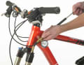 7. inflate the positive air chamber according to the specifications. The pressure in the fork serves as a guide. The pressure in the fork can be read exactly on the pressure gauge of the suspension fork pump.

8. sit on the bike again and check the cable tie again. The negative suspension travel should now be between 15 and 25 per cent of the total suspension travel.

9. rebound: Use the rebound adjuster to set the speed at which the fork rebounds. The position and colour of the adjustment wheel for the rebound varies from manufacturer to manufacturer.

For Magura: red (position varies); for Manitou: blue (bottom right); for RockShox: red (bottom right); for Fox: red (top right); for Marzocchi: colour varies (bottom right).

10. if the rebound is switched off (i.e. fully open), the fork rebounds extremely quickly and would bounce uncontrollably off-road. If the rebound is set too slowly (i.e. turned all the way down), the fork rebounds too slowly and cannot follow fast bumps off-road.

11 Therefore: To set the correct speed, first fully close the rebound. The direction is usually labelled with a "+", a "turtle" or similar symbols that mean "slow".