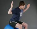 Strengthening the back neck and shoulder girdle muscles as well as the external rotators. Sit upright on the ball. Feet slightly above hip-width. Knees over the feet. Lift your sternum and pull your head back to create a double chin. Form a U shape with your arms and pull your elbows back. The thumbs point backwards.