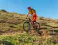 Approach: Approach in an upright position to scan the obstacle to be jumped over - in this case a stone field - and estimate where you need to jump off and land.