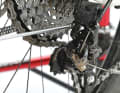3. adjust the chain wrap

 You now need to set the correct distance between the rear derailleur and the sprockets using the chain wrap screw. To do this, shift to the largest sprocket and turn the wrap screw in until the upper derailleur pulley is a few millimetres below the large sprocket. The derailleur pulley and sprocket should be directly in line.