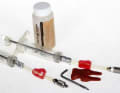 Bleeding kit for Avid, for example: two syringes, a 10mm and a 25mm Torx, a red spreader block and a bottle of DOT brake fluid

Syringes Robust syringes with stop and screw-on hose. The hose can be disconnected with a click valve.

Spreader block Conventional plastic block with bevelled edges to push the pistons apart. Alternative: Plastic tyre lever.